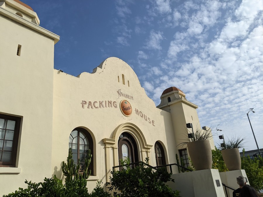 The Anaheim Packing House, a restored 1919 citrus packing building in downtown Anaheim now home to a food hall, on a clear day.