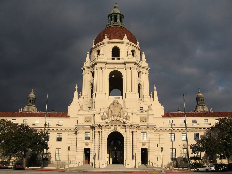 The dome and arched entry of Pasadena City Hall under a dark sky, Los Angeles County.