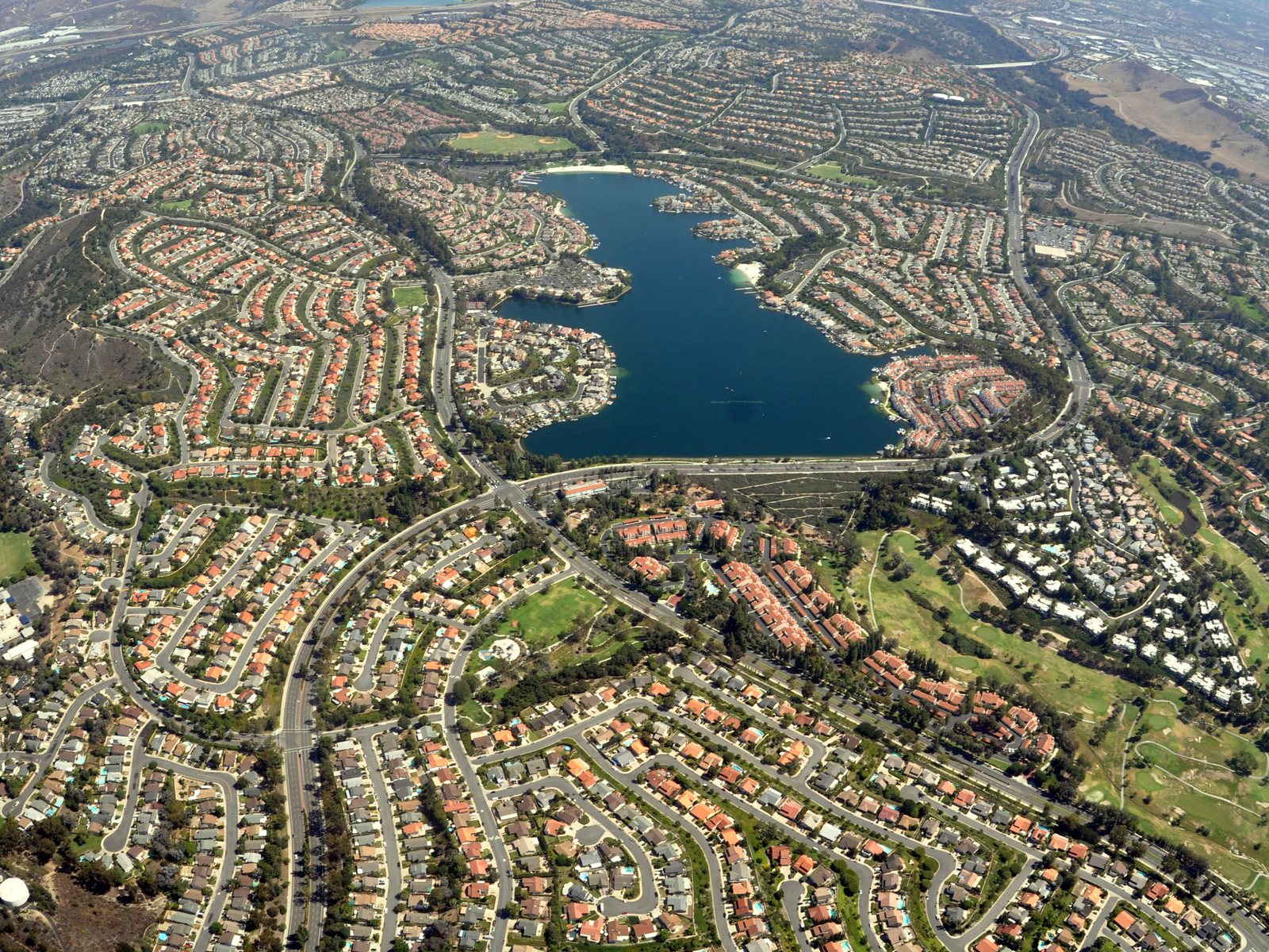 Hillside neighborhoods of Mission Viejo, Orange County, with homes stepped along the slopes above the valley roads.